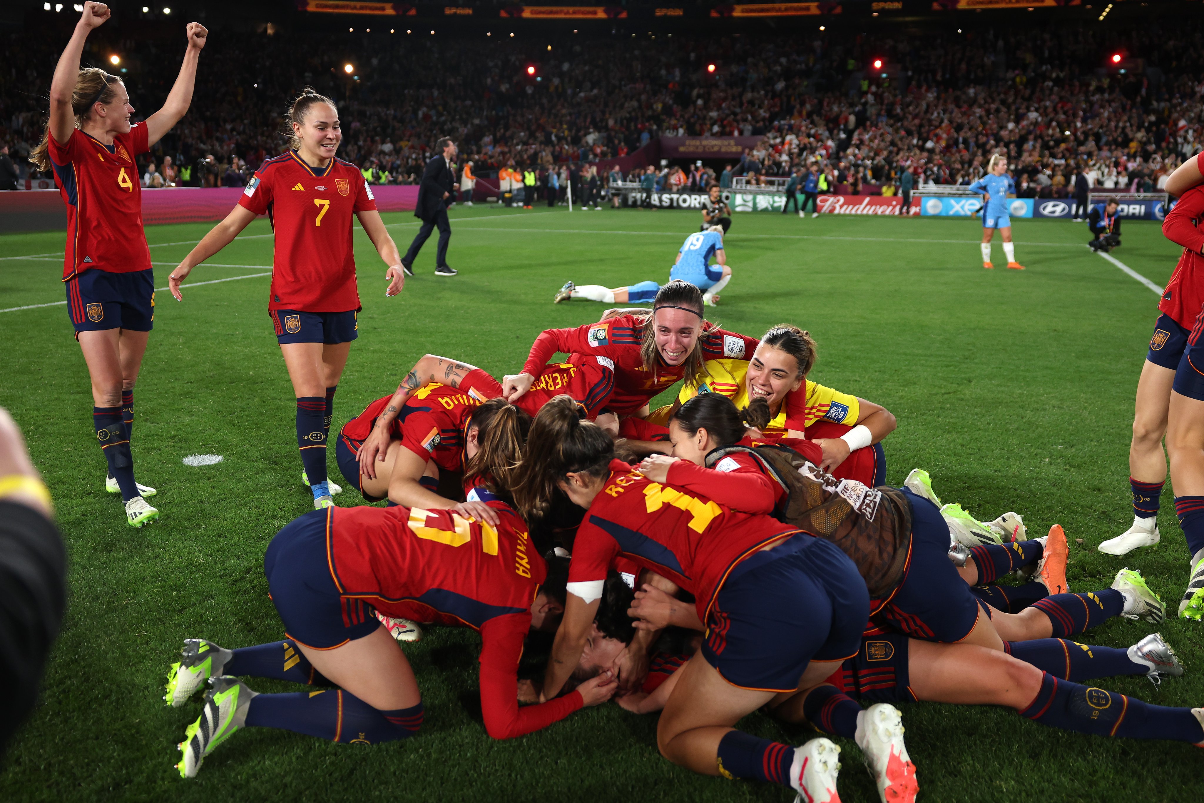 Spain's players huddle on the ground in celebration after winning the FIFA Women's World Cup